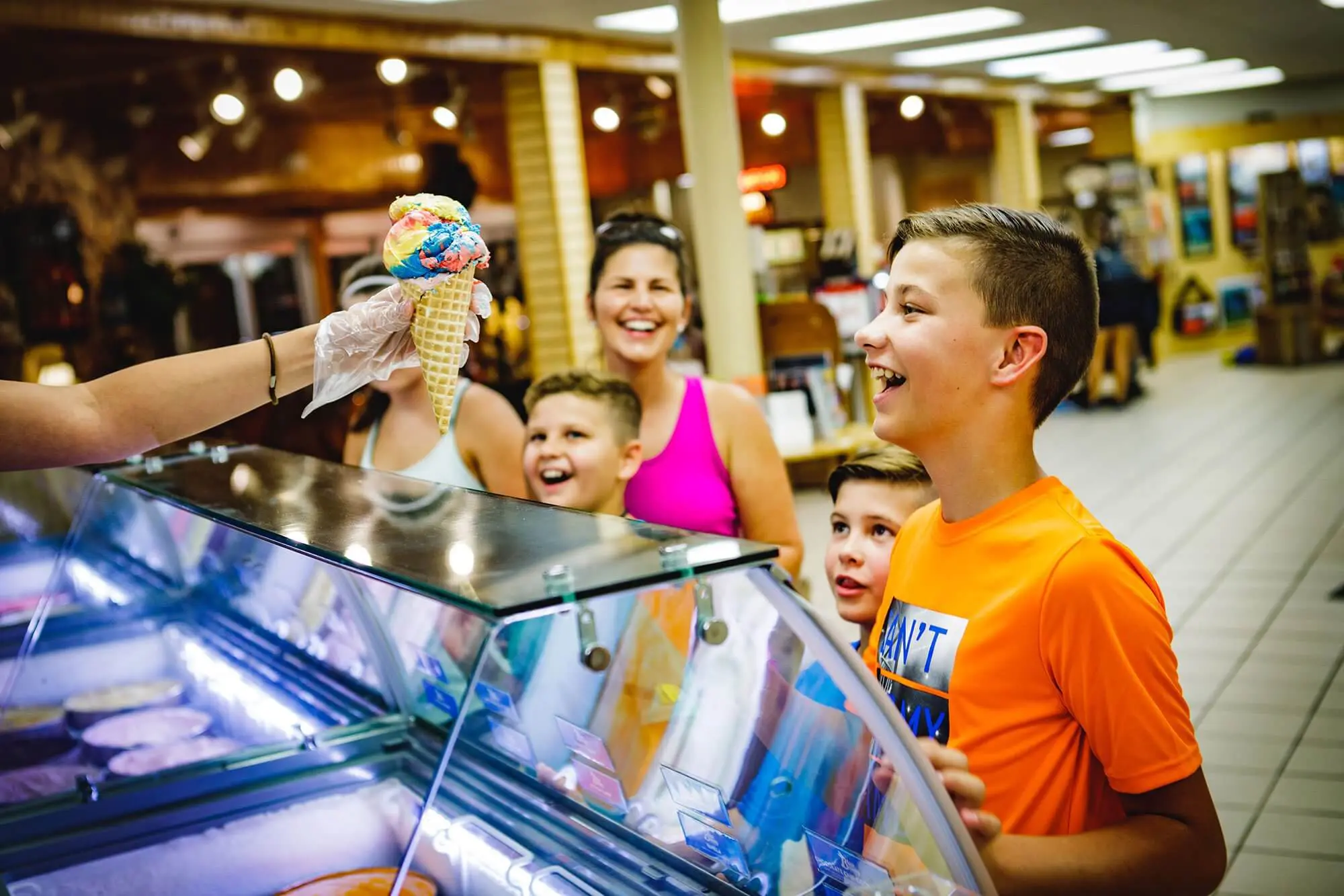 Hungry children and parent being served an ice cream cone at the Meramec Caverns candy shop