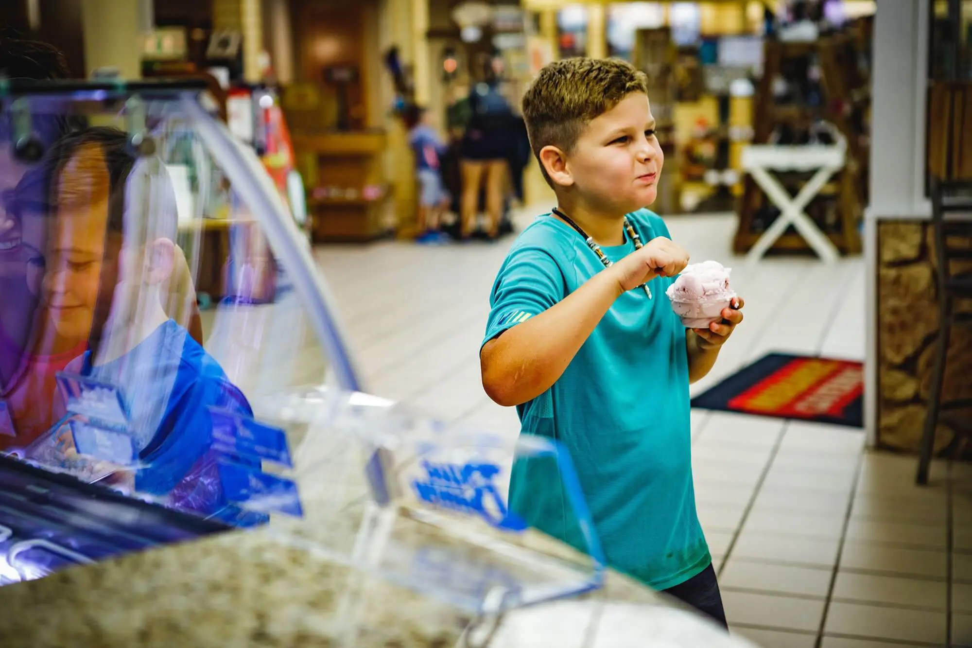 Young boy eating a bowl of ice cream at the Meramec Caverns candy shop