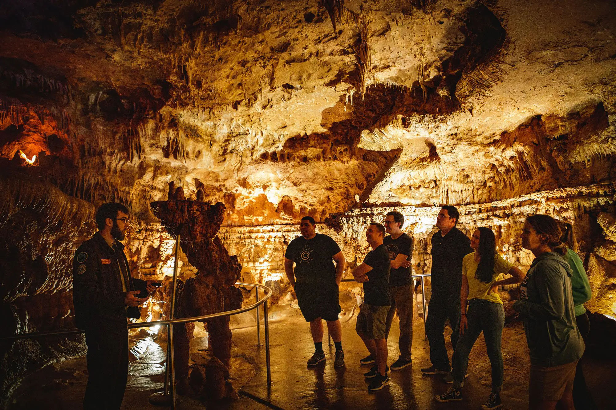 A group of young adults on a guided tour of Meramec Caverns