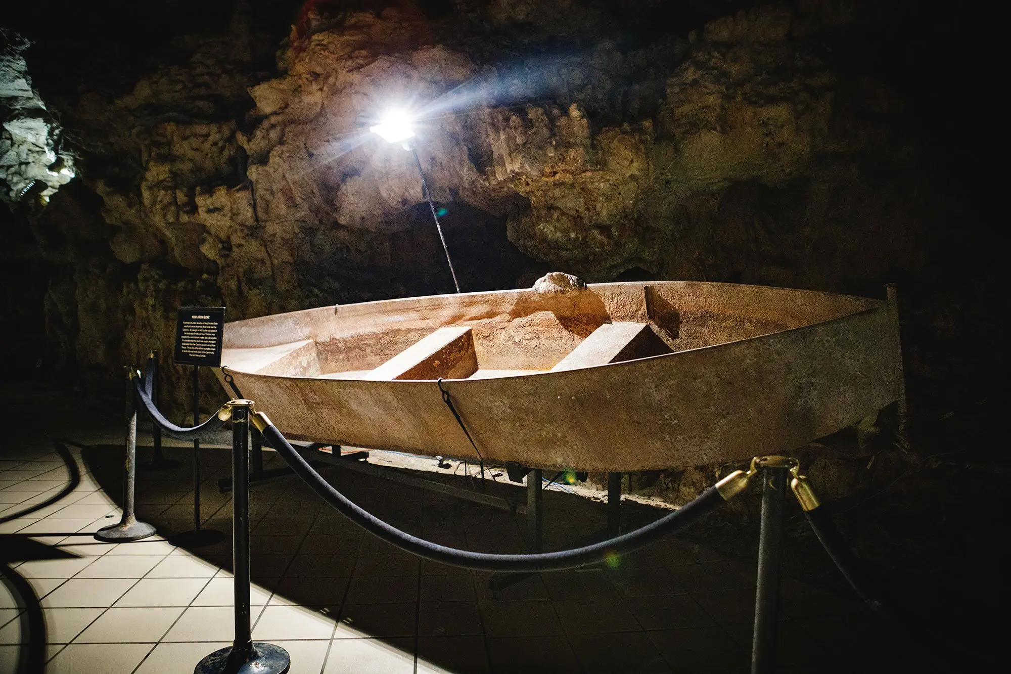 Museum display of an old rusty boat that was used to transport ammunition that was being stored inside of Meramec Caverns