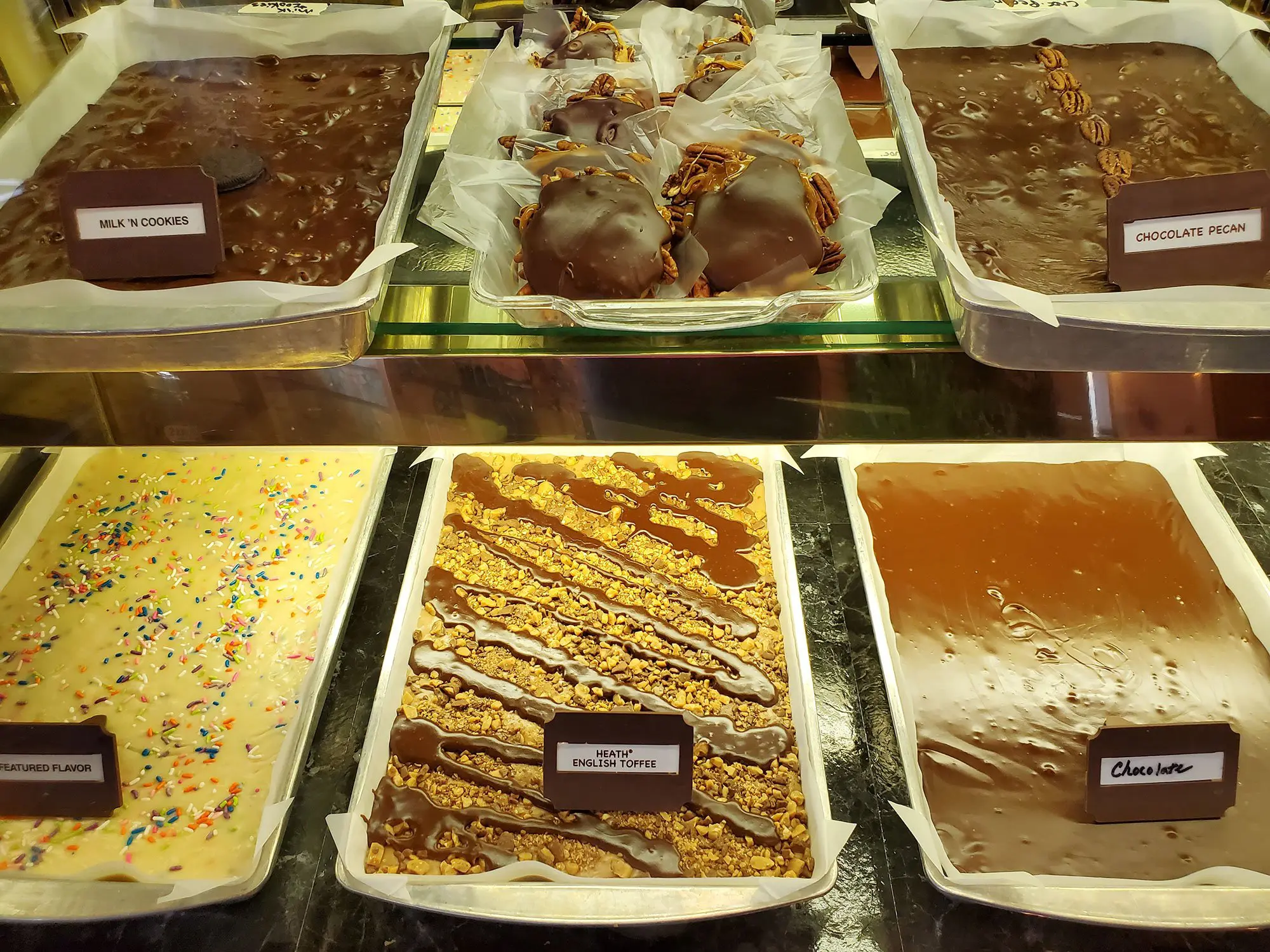 Head-on image of chocolate covered turtles dessert along with various types of fudge for sale at Meramec Caverns