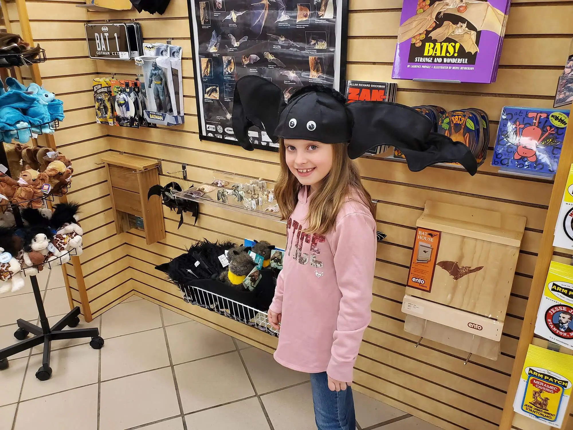 Young girl wearing a bat-shaped hat at the Meramec Caverns gift shop